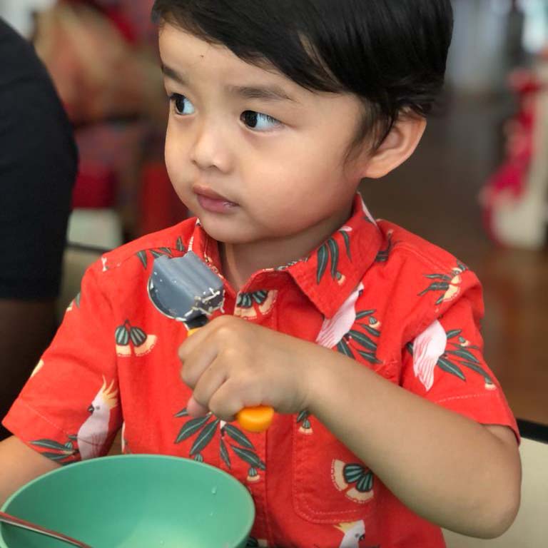 Noah eating his favourite food - Oh Mak Gua’s Kueh Lapis. (Photo: Mrs Liz Lee)